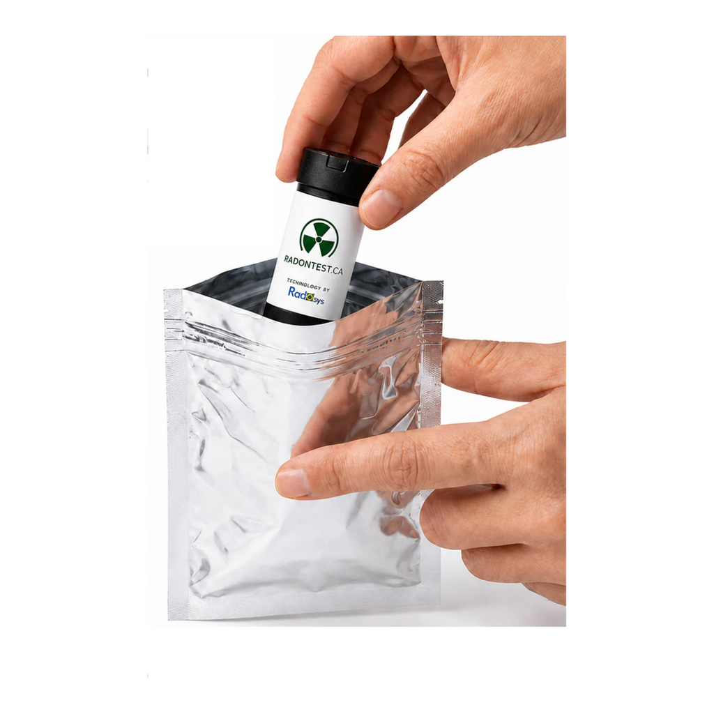 Hand placing the alpha-track radon detector into its resealable silver foil return bag